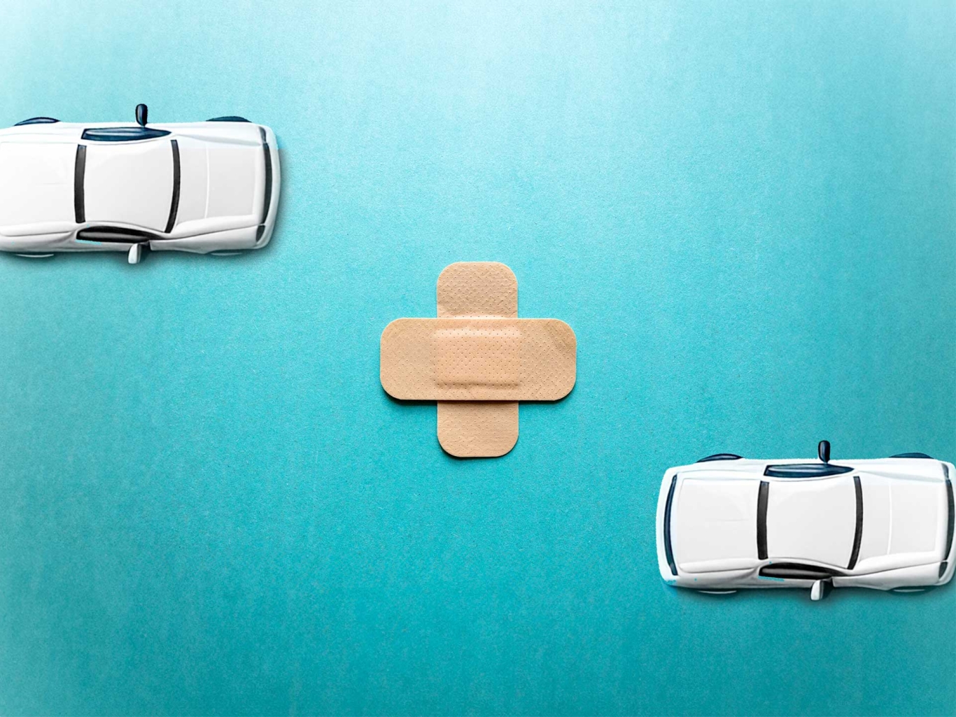 Plaster in the centre with two white toy cars either side.